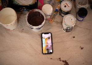 Paint surrounds a phone where the image of the A-Mural is on 